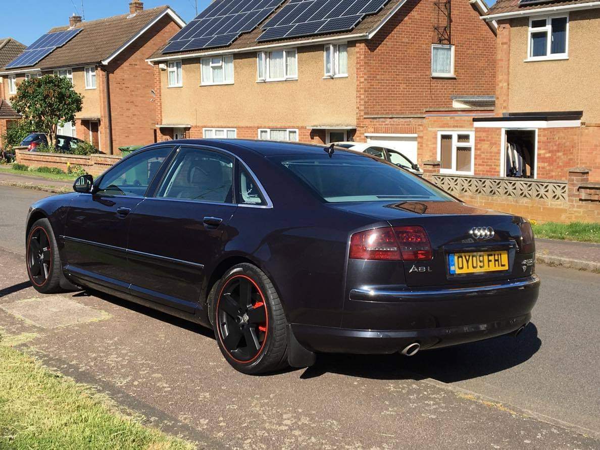 The same dark Audi photographed at a rear three-quarter angle