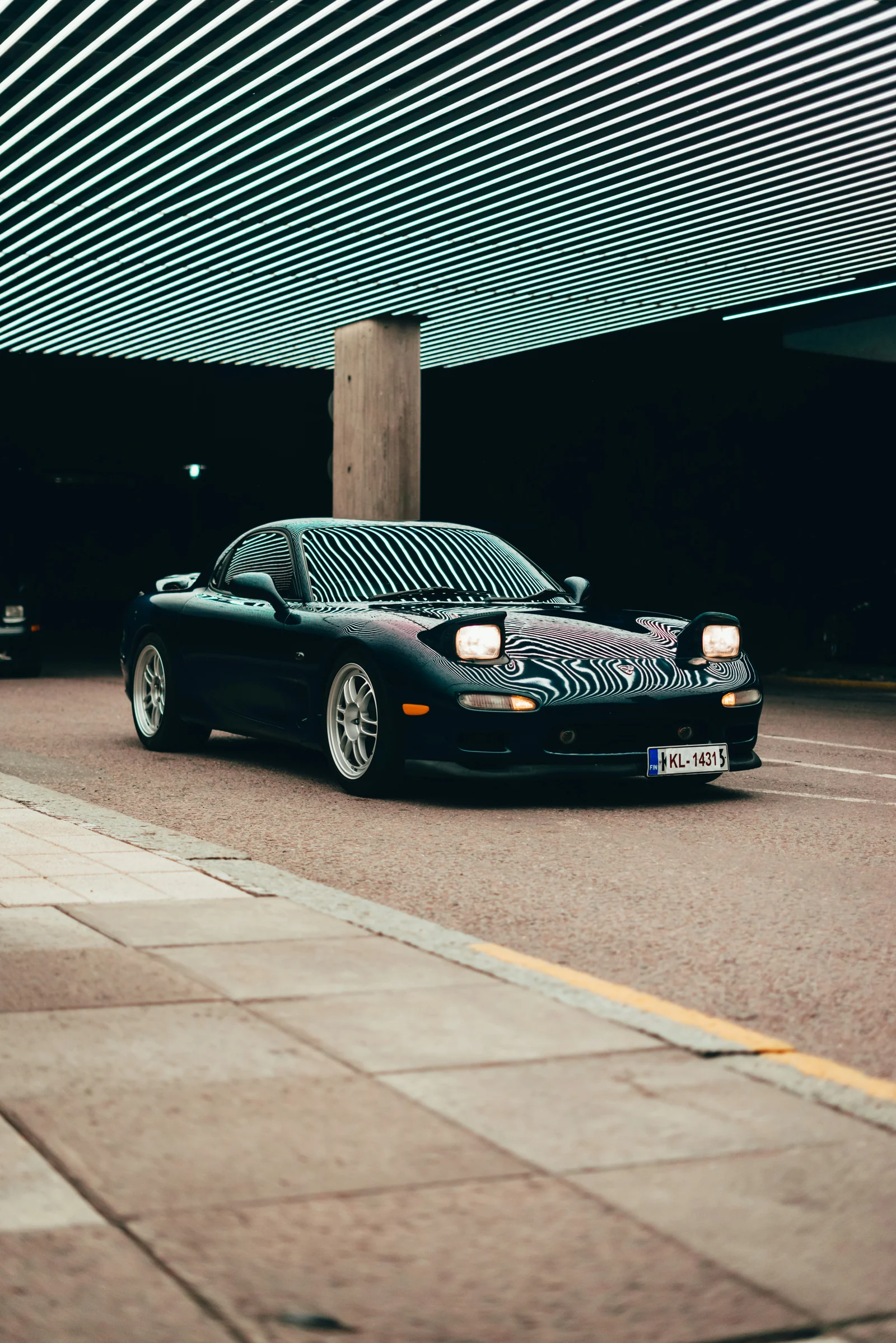 Mazda RX-7 reflecting lines of overhead lighting, photograph supplied by the owner